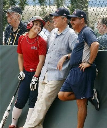 President Bush talks with Andrea Duran and head coach Mike Candrea as he visits the practice of the U.S. women's softball team at the 2008 Summer Olympic games in Beijing, China Saturday, Aug. 9, 2008. (AP Photo/Gerald Herbert)