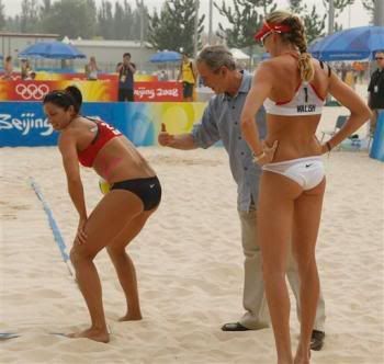 U.S. President George W. Bush playfully pats the back of U.S. Women's Beach Volleyball team player Misty May-Treanor (L) at her invitation while visiting the Chaoyang Park Beach Volleyball Grounds at the 2008 Summer Olympic Games in Beijing, China, August 9, 2008. Teammate Kerri Walsh (R) watches. (Reuters)
